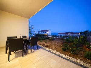 a dining room with a view of the ocean at Apartments Ivy - modern with terrace in Bol