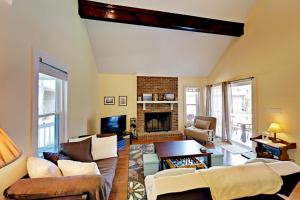 a living room with couches and a fireplace at Cozy Beach Retreat in Myrtle Beach