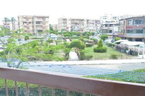 a view of a park from a balcony at Maamoura Beach 1 in Alexandria