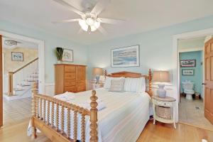 a bedroom with a bed and a ceiling fan at 2714 Bayonne Street in Sullivans Island