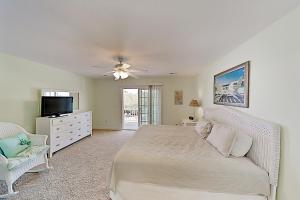 a bedroom with a bed and a ceiling fan at Sun Rays Getaway in Myrtle Beach
