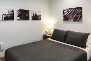 a bedroom with a bed and some pictures on the wall at Atrium Unit 105 in Seattle