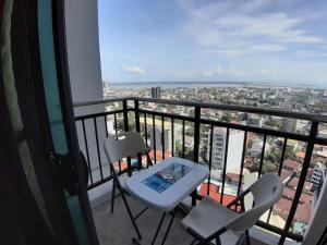 a balcony with a table and two chairs and a view at Cebu City Suites Ramos Tower by P&J in Cebu City