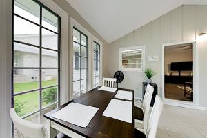 a dining room with a wooden table and white chairs at Quiet Oasis in Myrtle Beach