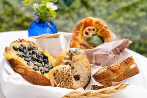 a basket of bread and pastries on a table at Arima Koyado Uraku in Kobe