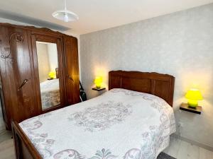una camera con un letto con due lampade e uno specchio di Gîte Le Tholy, 2 pièces, 4 personnes - FR-1-589-129 a Le Tholy