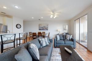 a living room with a couch and a table at Dauphin Island Beach Club #210 in Dauphin Island