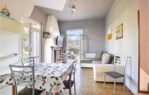 a living room with a table and chairs and a couch at Lovely Home In Manerba Del Garda With Kitchen in Manerba del Garda