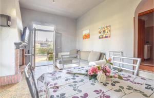 a living room with a table with flowers on it at Lovely Home In Manerba Del Garda With Kitchen in Manerba del Garda