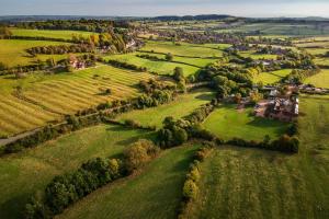 an aerial view of a village in a green field at The Sunshine Annex at Lower Fields Farm in Napton on the Hill