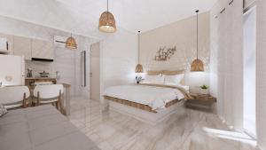 a white bedroom with a bed and a dining room at Chouzourakis Studios in Keratokampos