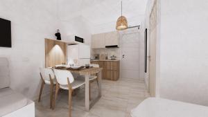 a kitchen and dining room with a table and chairs at Chouzourakis Studios in Keratokampos