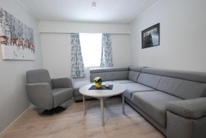 a living room with a couch and a table and a chair at Fossanåsen Hotel in Flesberg