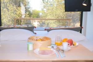 a table with a tray of food on a bed at Desertas Beach and Sport in Costa Nova