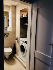 a bathroom with a washing machine and a toilet at Apartament na Okulickiego - Centrum !! in Stalowa Wola