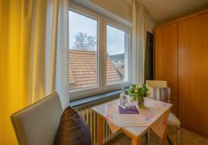 a dining room with a table and a large window at Linde Oberachern in Achern