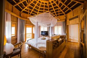 a bedroom with a bed and a desk in a room at Le Champ Tu Le Resort Hot Spring & Spa in Yen Bai