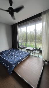 a bedroom with a bed and a ceiling fan at Galaxy House with seaview balcony- JB PONTIAN in Pontian Kecil