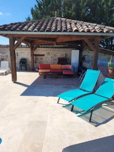 a patio with two chairs and a pavilion at UN AIR DE VACANCES in Layrac