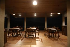 a group of tables and chairs in a room at Icy Falls - Ohiya in Ohiya