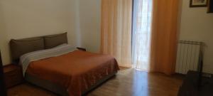 a bedroom with a bed and a large window at Sweet Home Bari in Bari