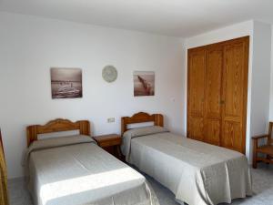 Posteľ alebo postele v izbe v ubytovaní Hostal CAN GALLU