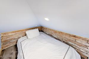 a bed in a room with a wooden wall at The Carriage House in Seattle