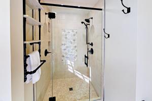 a shower with a glass door in a bathroom at The Carriage House in Seattle
