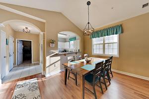 a kitchen and dining room with a table and chairs at Sand, Sun, & River Crossing in North Myrtle Beach