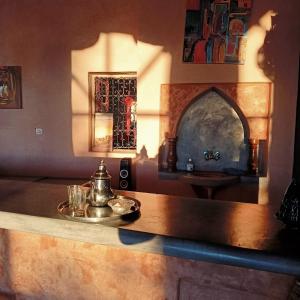 una cucina con tavolo e bollitore per il tè. di LESCALE DE OUARZAZATE a Ouarzazate