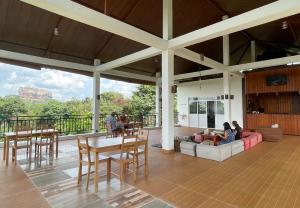 a living room with people sitting on a couch at Iwamisou in Sigiriya