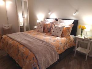 a bedroom with a large bed with pillows at The Nook Cottage In The Heart Of Northumberland in Wark