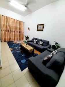 a living room with a couch and a table at AMZ HOMESTAY in Masjid Tanah