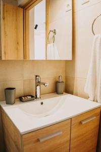 a bathroom with a sink and a mirror at Loutraki Hidden Gem Ι in Loutraki +19 photos