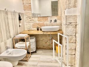 a bathroom with a sink and a toilet at Antica Pietra in Polignano a Mare