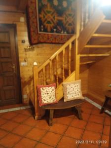 two pillows sitting on a bench next to a staircase at Los Arces in Elosu