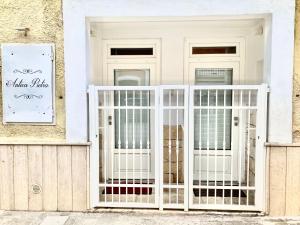 a white gate in front of a house at Antica Pietra in Polignano a Mare
