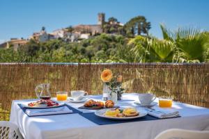 a table with plates of food and orange juice at Finca Son Arnau in Selva