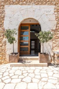 an entrance to a building with a door and two trees at Finca Son Arnau in Selva +121 photos