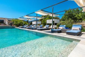 a swimming pool with lounge chairs and a swimming pool at Finca Son Arnau in El Port de la Selva