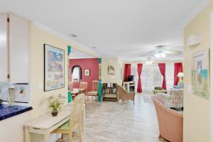 a kitchen and living room with a table and chairs at Heron's Watch in Grayton Beach