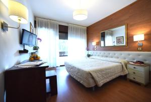 Postel nebo postele na pokoji v ubytování Hotel Corona