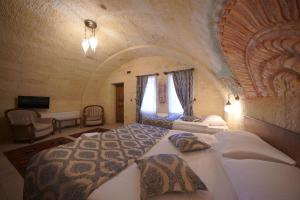 Ένα ή περισσότερα κρεβάτια σε δωμάτιο στο Grand Cappadocia Hotel +94 φωτογραφίες