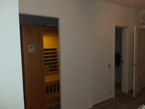 a hallway with a mirror and a room with a closet at Apartmani Nikola in Vrnjačka Banja