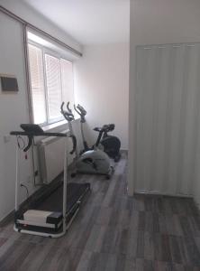 a gym with a treadmill and a exercise bike at Apartmani Nikola in Vrnjačka Banja