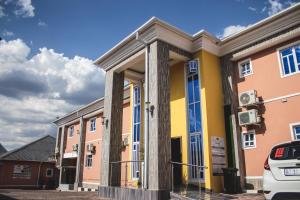 a building with columns in a parking lot at Gold Crown International Hotel Johannesburg in Johannesburg