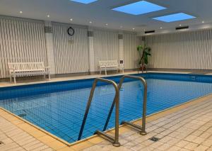a large swimming pool in a building with a pool at Haus Oland Whg 15 in Wyk auf Föhr