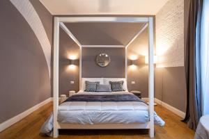a bedroom with a canopy bed with a mirror at Cardilli Luxury Rooms in Rome