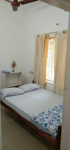 a bedroom with a bed and a window at Jestine Homestay in Cochin