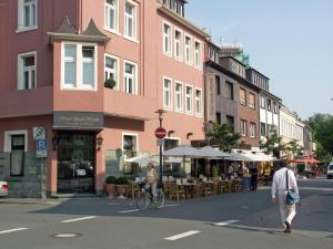 a man riding a bike down a city street at Hotel Stadt Hamm in Hamm